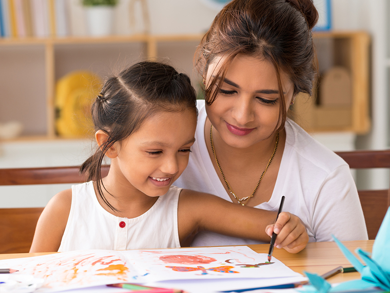 Preschool teacher and child